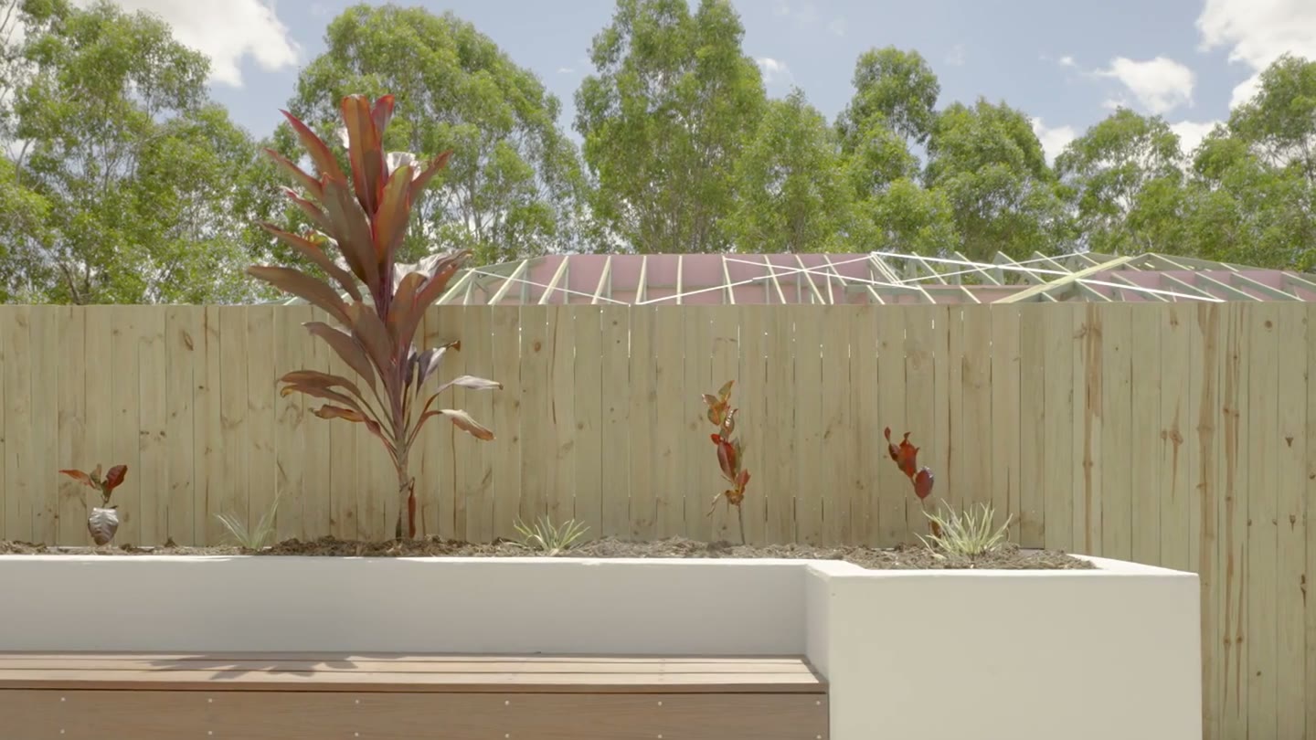 Private courtyard with a bench seat and garden bed