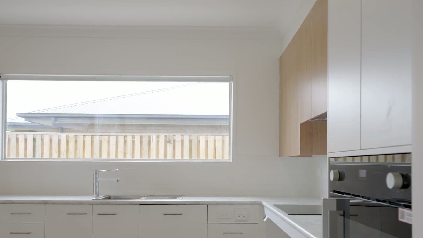 Kitchen with low benches and timber-look cupboards